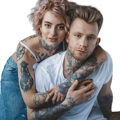 Tattooed couple posing closely, with the woman leaning over the man and wrapping her arms around his shoulders.